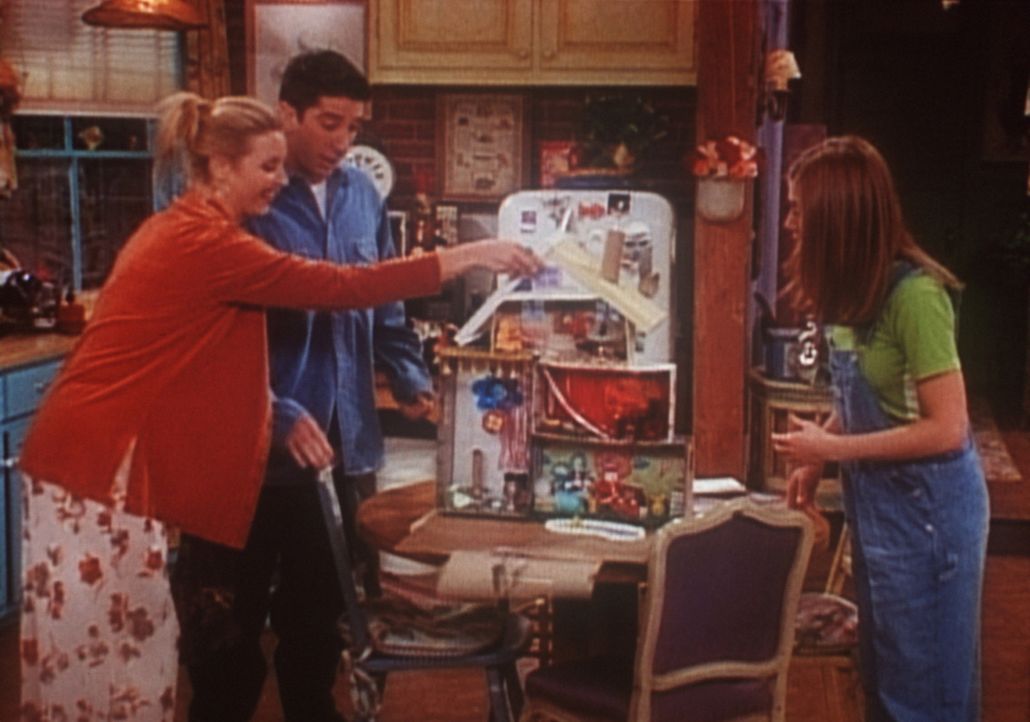 Phoebe (Lisa Kudrow, l.), Ross (David Schwimmer, M.) und Rachel (Jennifer Aniston, r.) beschäftigen sich mit dem Puppenhaus. - Bildquelle: TM+  2000 WARNER BROS.